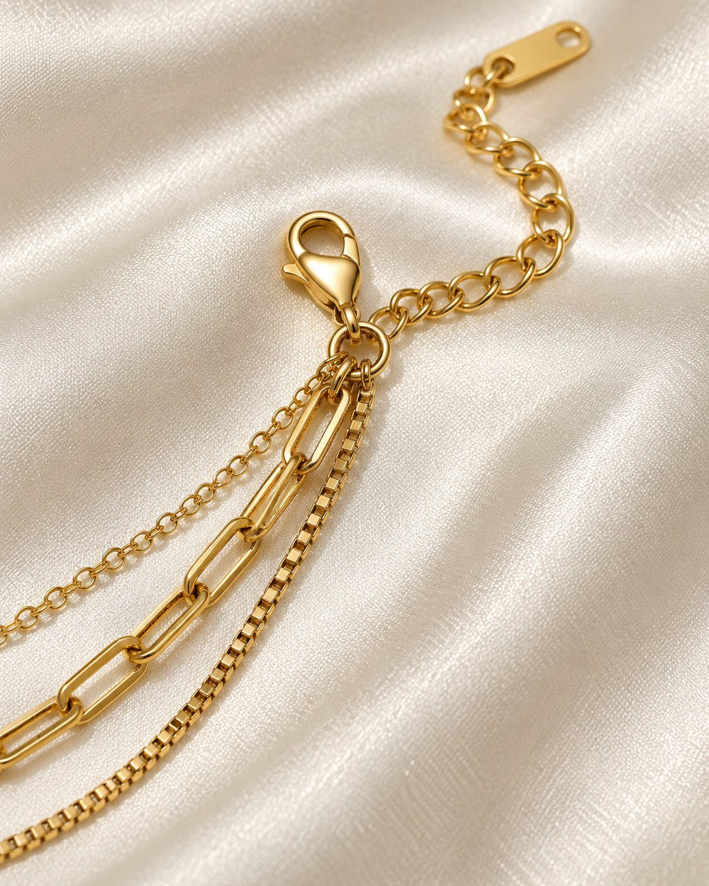 Close-up of the three chains joining at the lobster clasp and extender