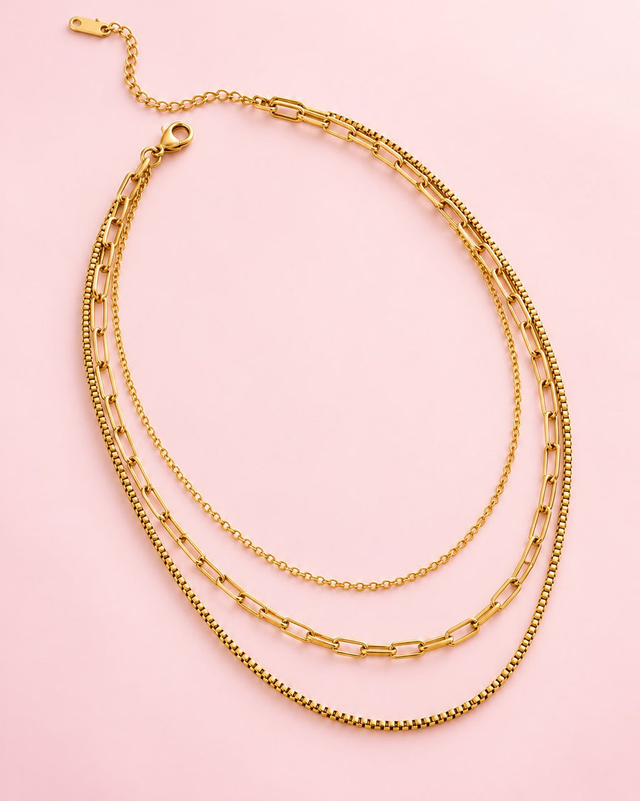 Gold-tone layered necklace: a fine chain, a paperclip chain and a box chain on one clasp