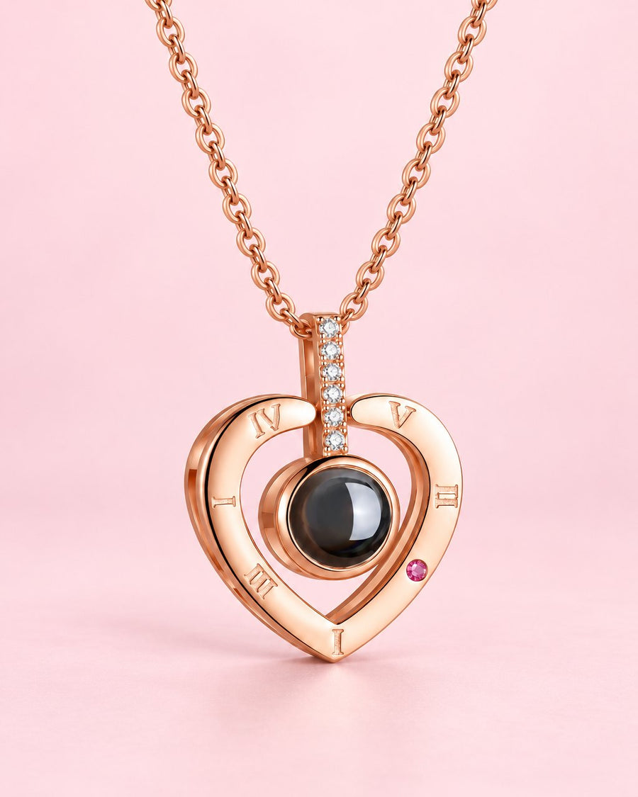 Rose gold-tone open heart necklace with a small black projection stone