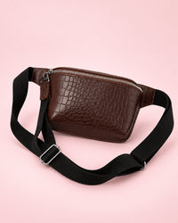 Coffee-brown croc-embossed belt bag with a wide black strap