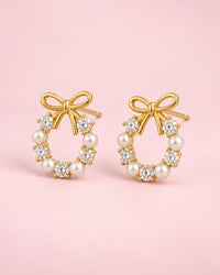 Pair of gold-tone bow studs, each on a small wreath of clear stones and pearl-look beads