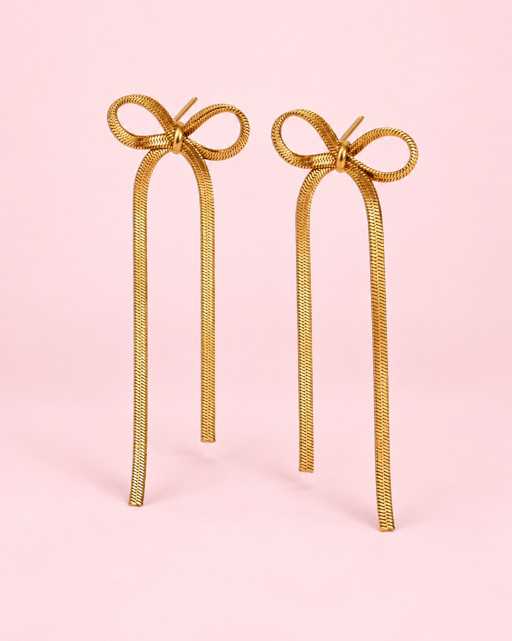 Pair of gold-tone chain bow earrings with long, flat chain tails