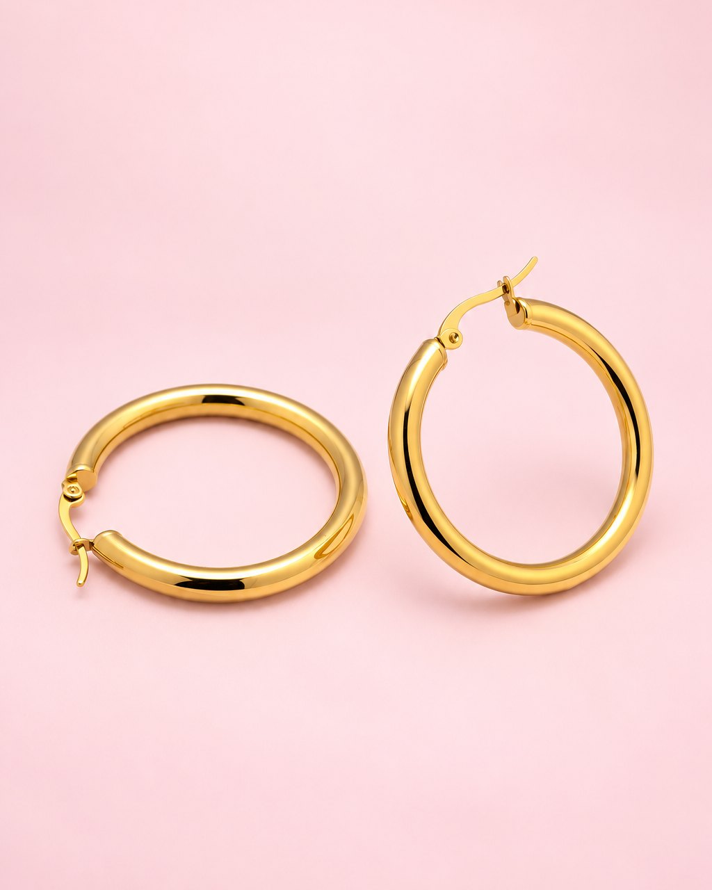 Pair of glossy gold-tone chunky hoop earrings with hinged posts