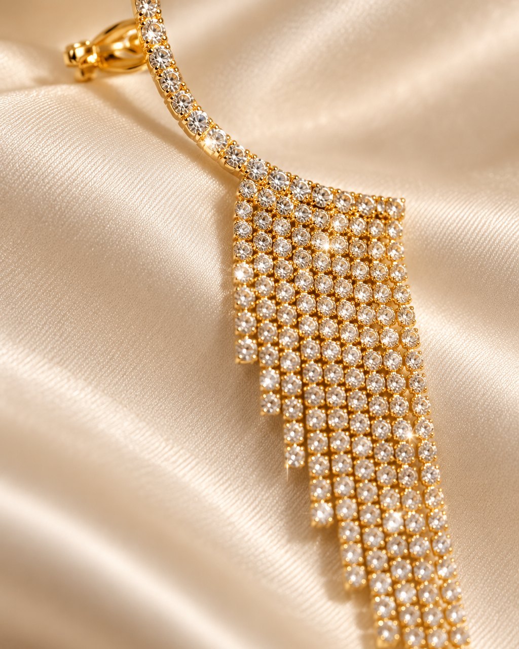 Close-up of the curved rhinestone line, the small open cuff and the top of the fringe strands