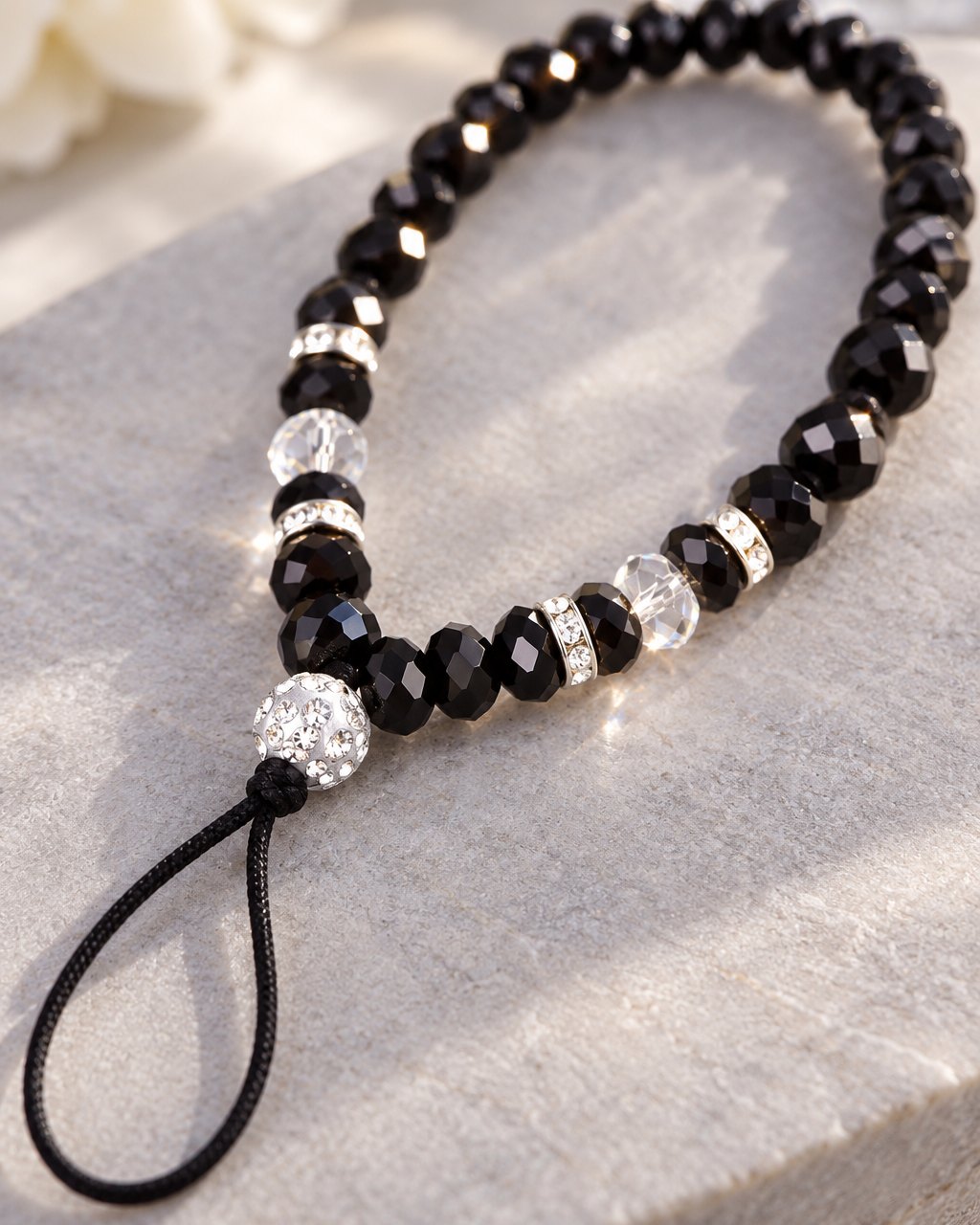 Close-up of the faceted black crystal beads, sparkly spacers and the thin cord loop