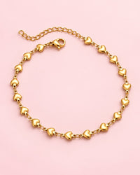 Gold-tone anklet made of small puffed hearts with a lobster clasp