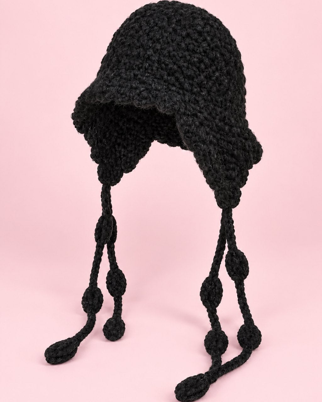 Black chunky hand-knit bonnet with long knotted ties