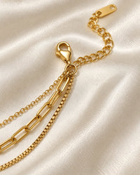 Close-up of the three chains joining at the lobster clasp and extender
