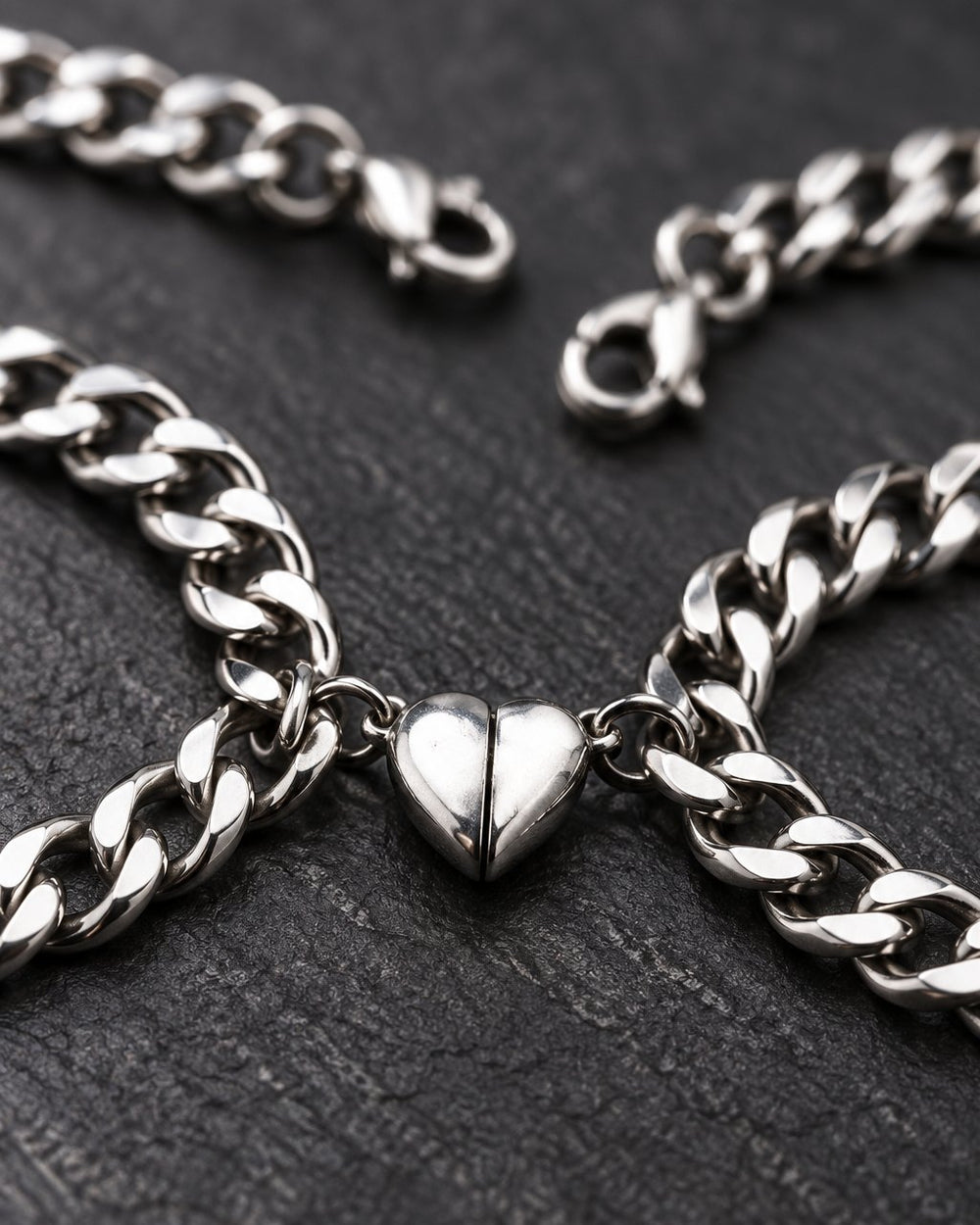 Close-up of the two polished heart halves clicked together between the curb chain links