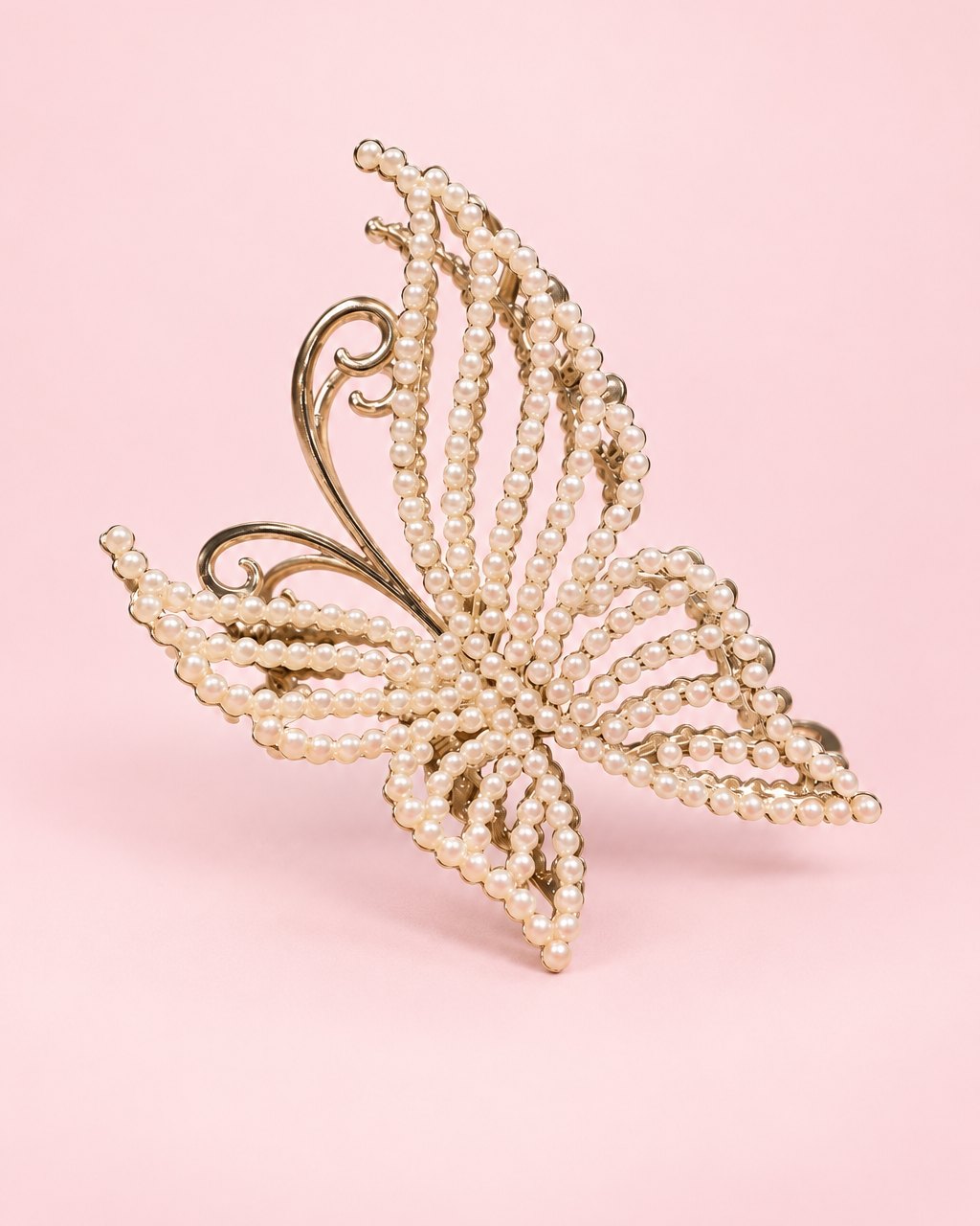 Gold-tone butterfly claw clip with wings beaded in small faux pearls