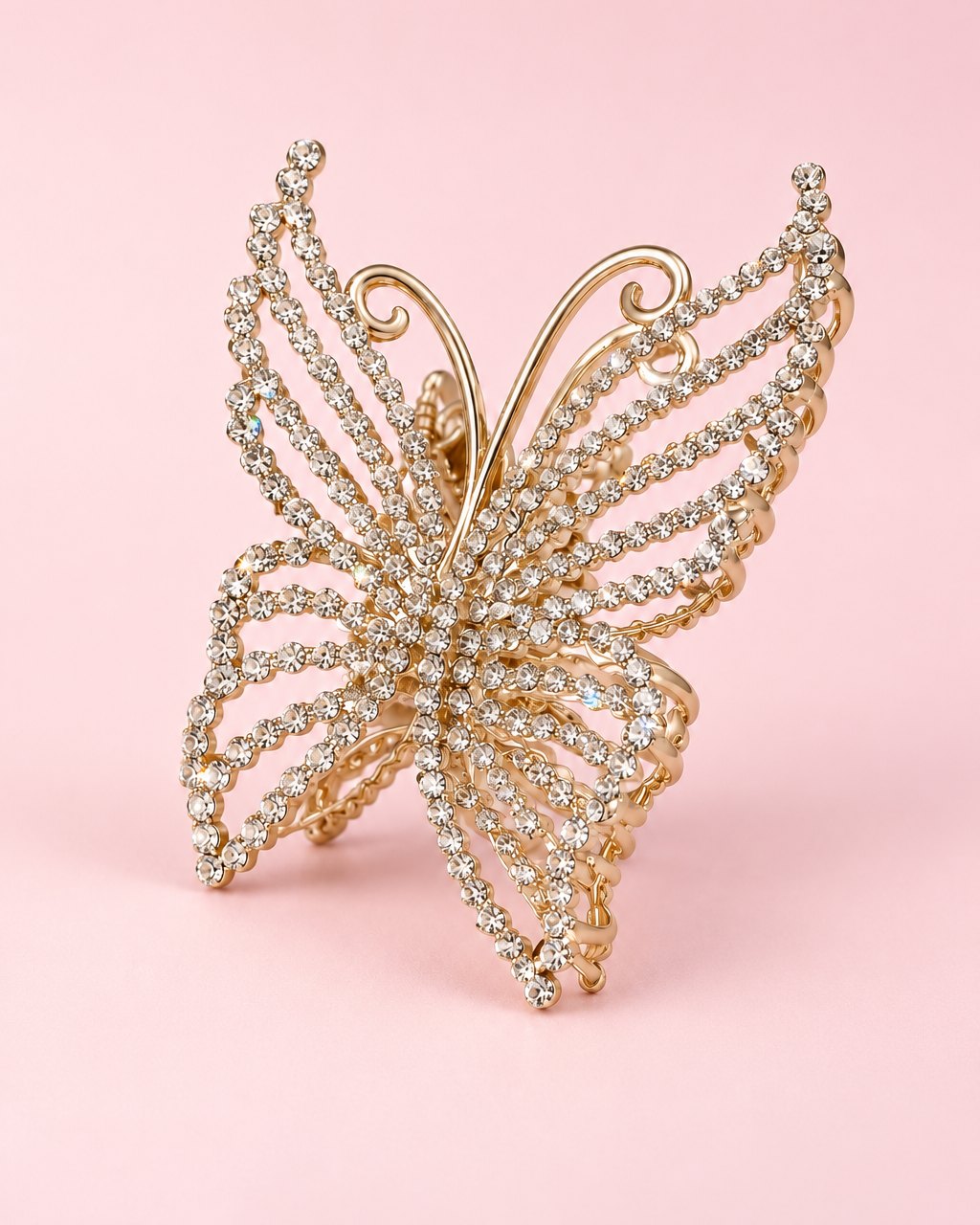 Gold-tone butterfly claw clip with wings set with clear rhinestones