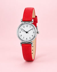 Petite silver-tone watch with a white dial on a slim red strap