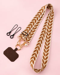 Cream woven phone strap with a brown leaf pattern