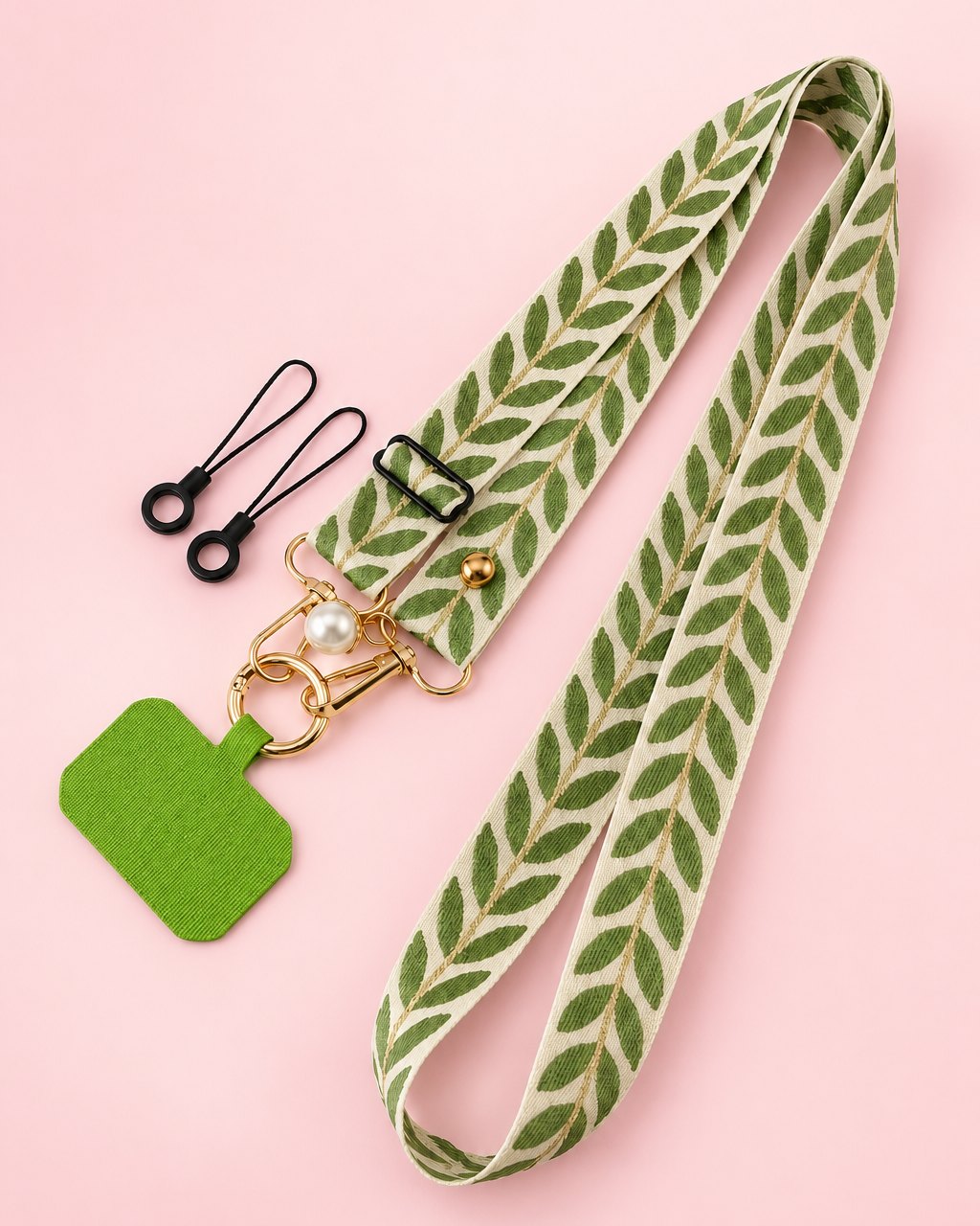 Cream woven phone strap with a green leaf pattern