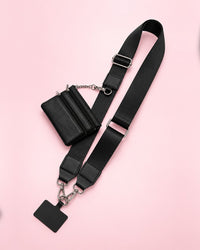 Black crossbody phone strap with silver-tone clasps, a phone tab and a mini black zip pouch
