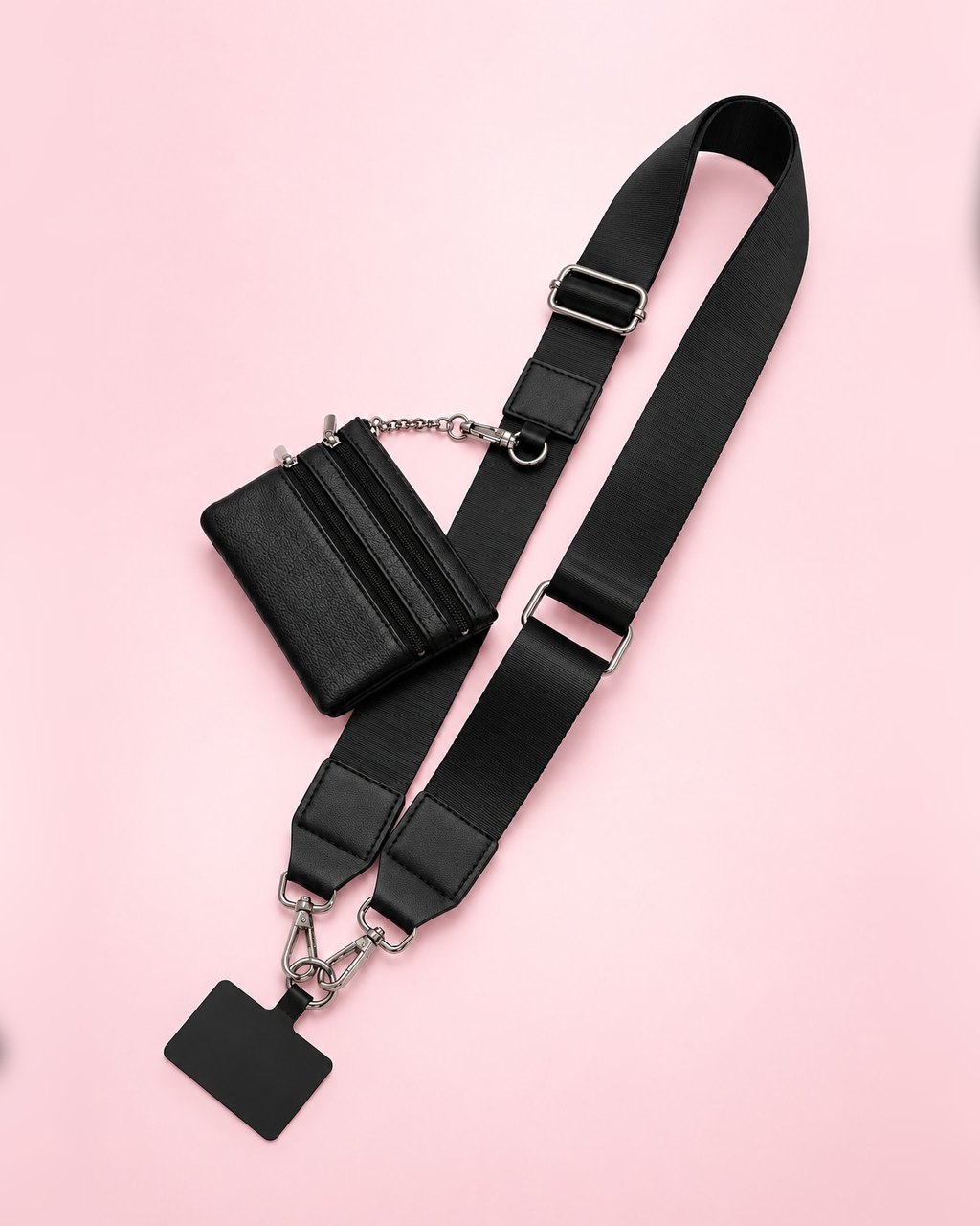 Black crossbody phone strap with silver-tone clasps, a phone tab and a mini black zip pouch