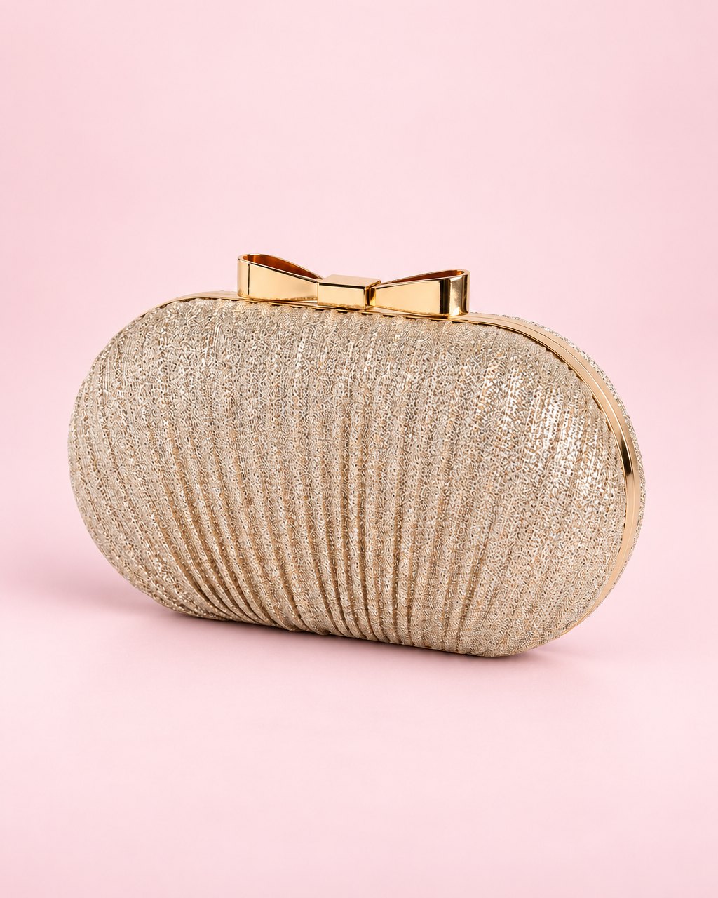 Gold-tone pleated oval clutch with a small bow on its frame