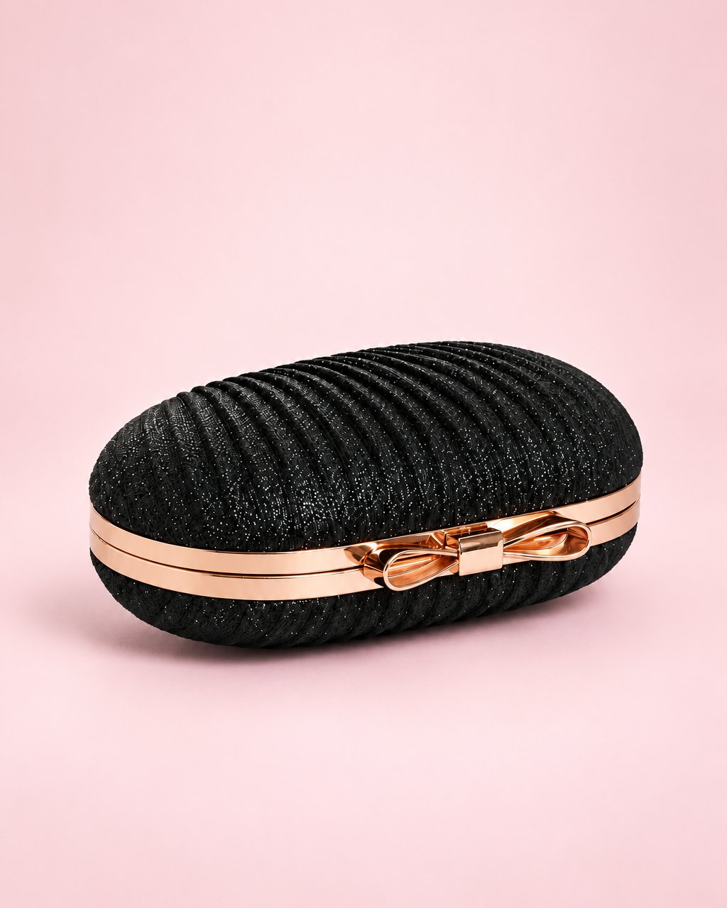 Black pleated clutch with a gold-tone frame and bow