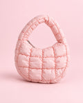 Pink puffy quilted mini bag with a short top handle