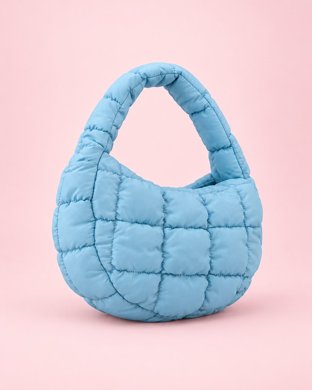 Light blue puffy quilted mini bag with a short top handle
