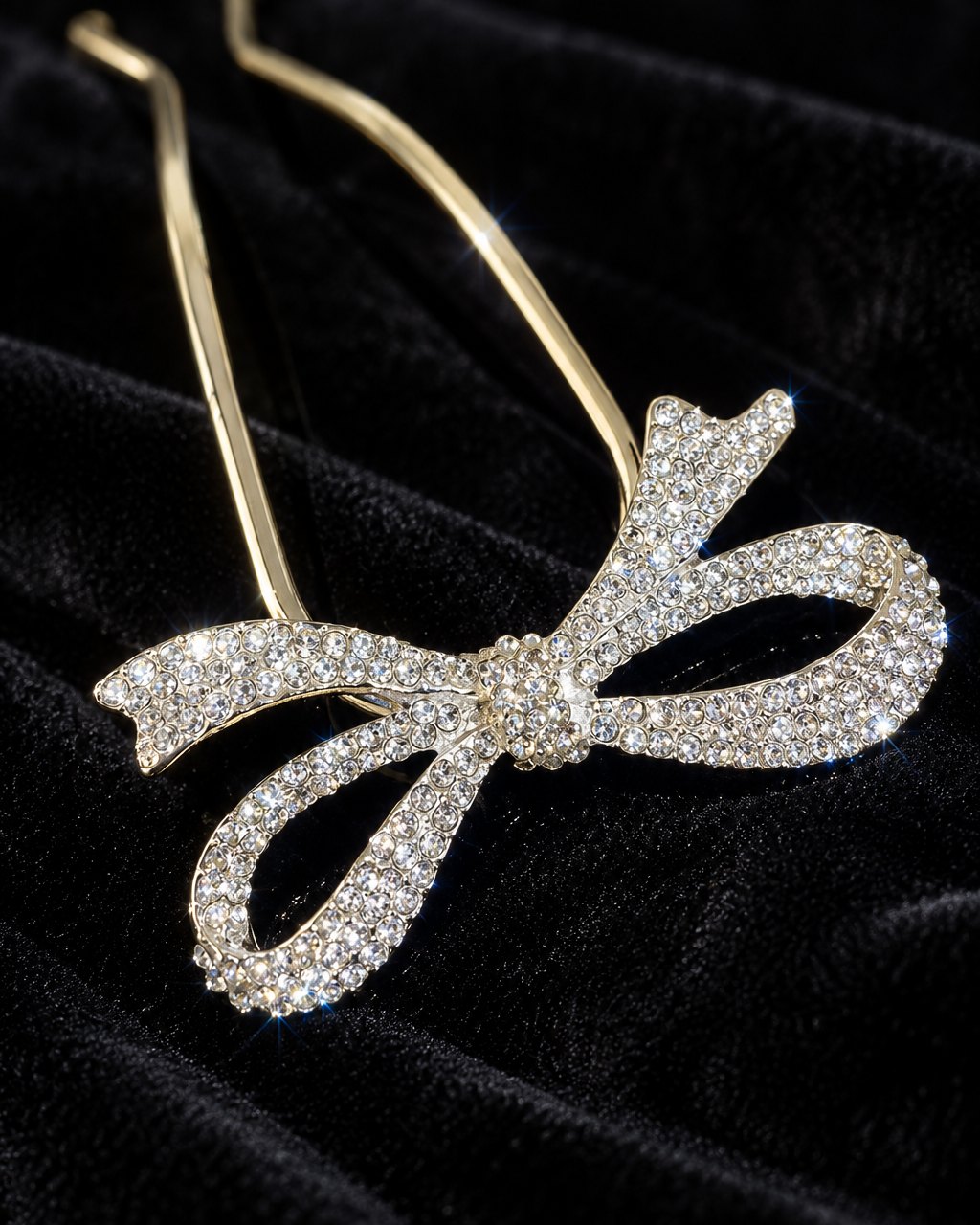 Close-up of the clear rhinestones paved over the loops and tails of the bow