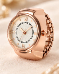 Close-up of the ring watch dial with Roman numerals, slim hands and the small crown at the side