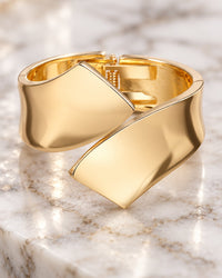 Close-up of the two mirror-polished folded ends crossing over on top of the cuff