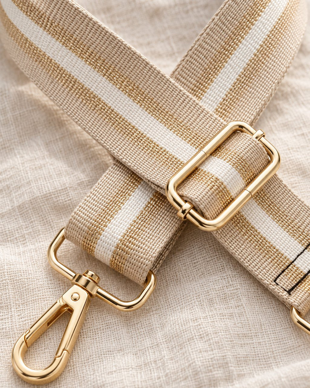 Close-up of the woven stripes with gold thread and the gold-tone swivel clip