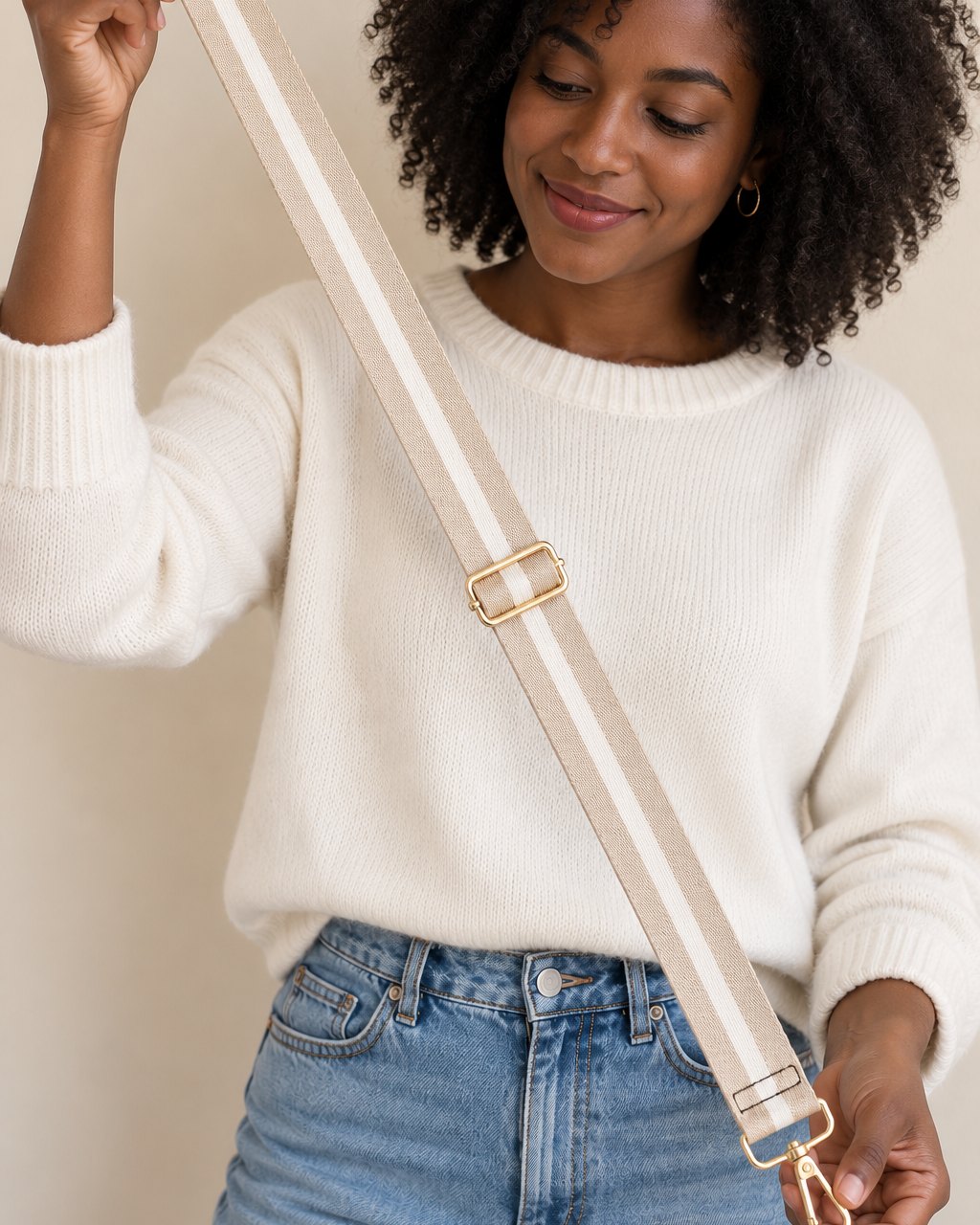 The striped strap held at full length between two hands, longer than an arm span is wide