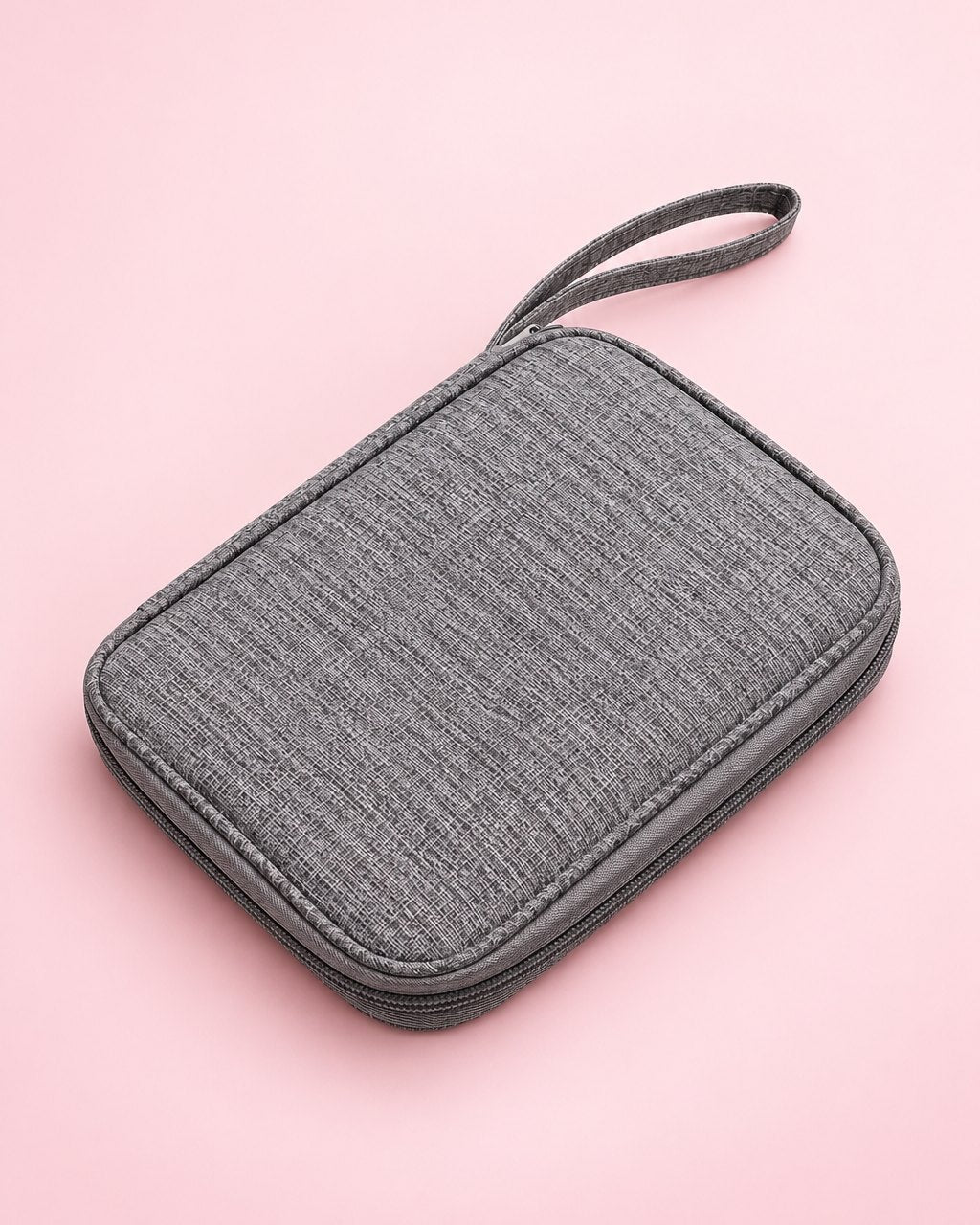 Grey zip cable organiser pouch, closed, with a wrist loop
