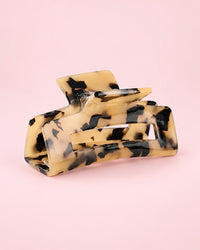 Light tortoise acetate claw clip with an open rectangle shape