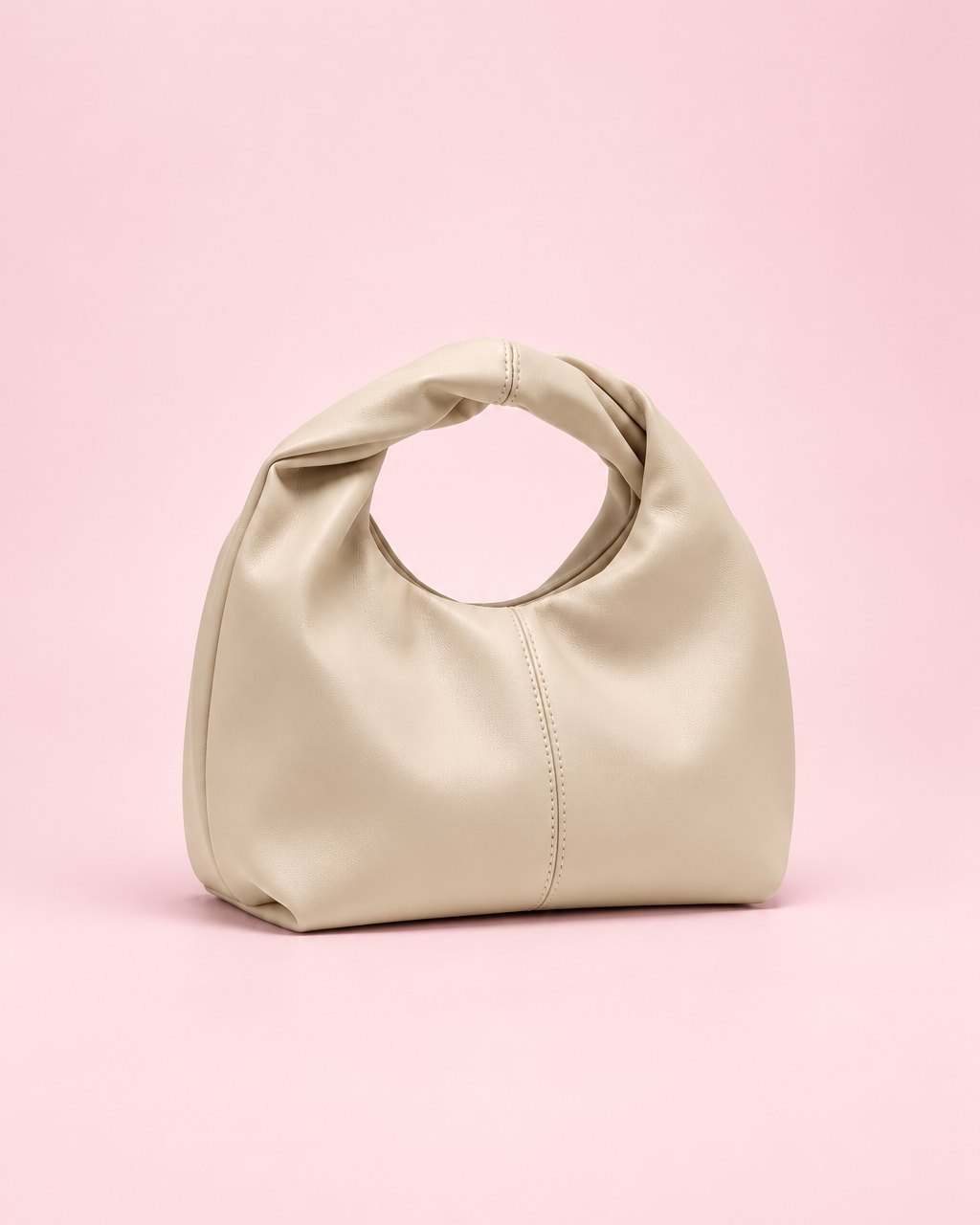 Beige soft mini bag with a twisted top handle