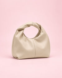 Beige soft mini bag with a twisted top handle